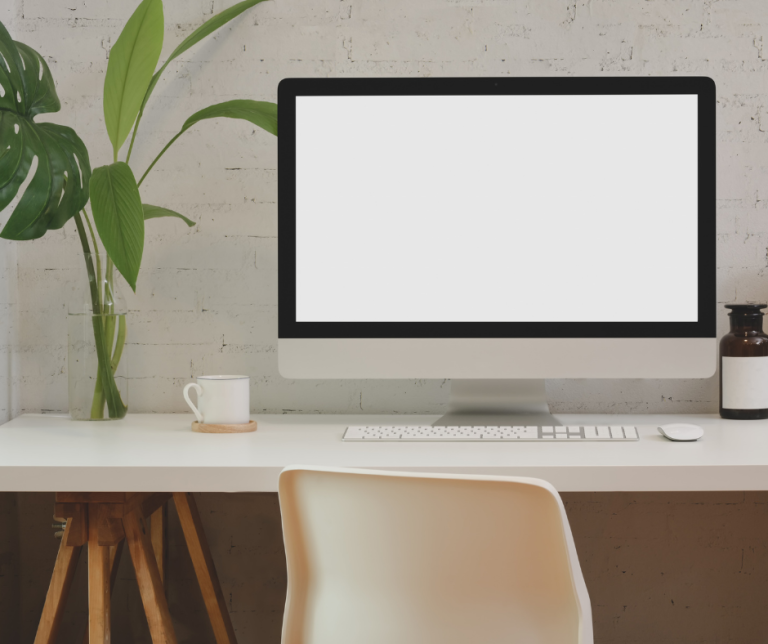 A desktop computer sits on a clean desk.
