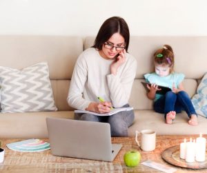 Child on a tablet while mother works.