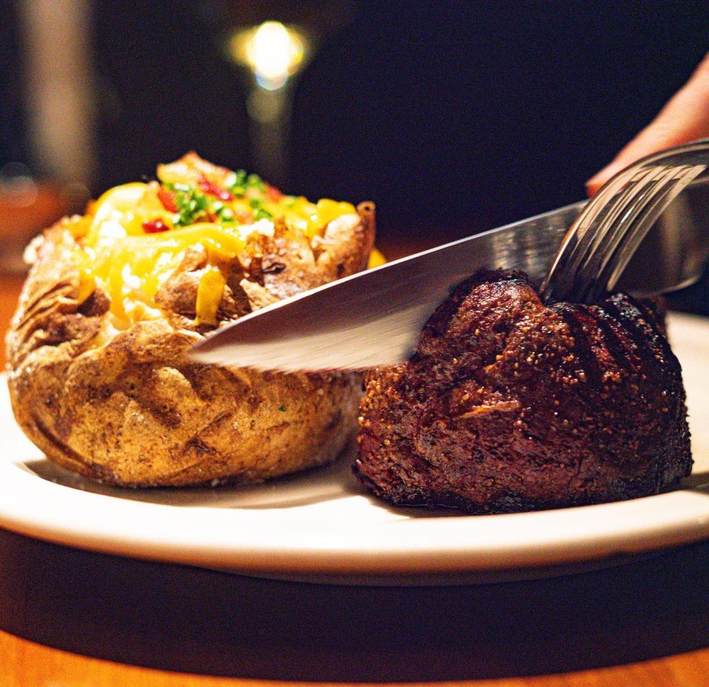 baked potato and steak on a plate