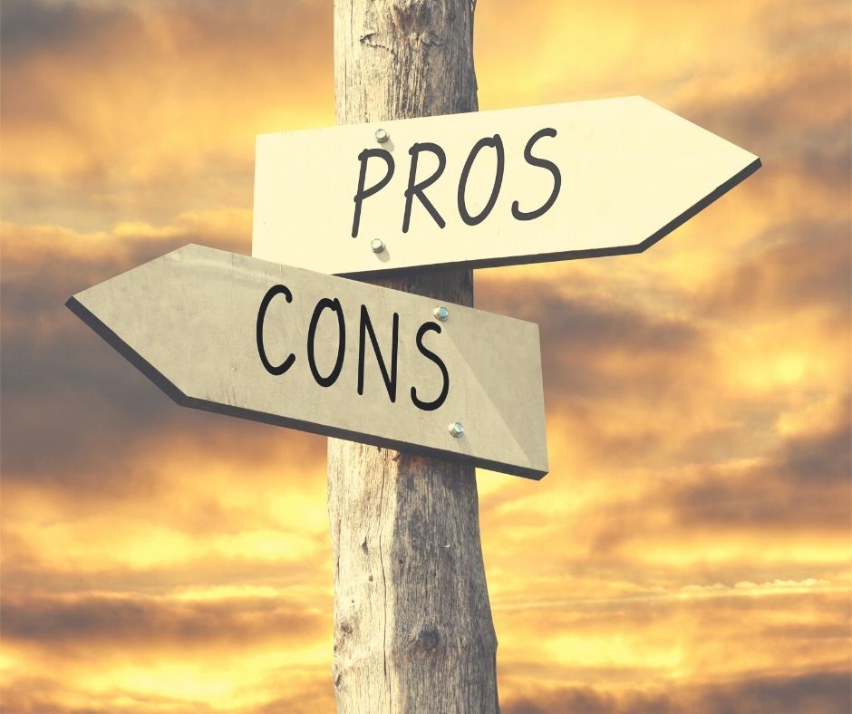 An image of the sky with a sign pointing two directions for pros and cons.