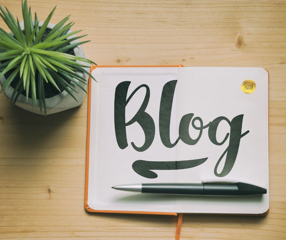 Blog written on a blank page on a desk for Blogging article.