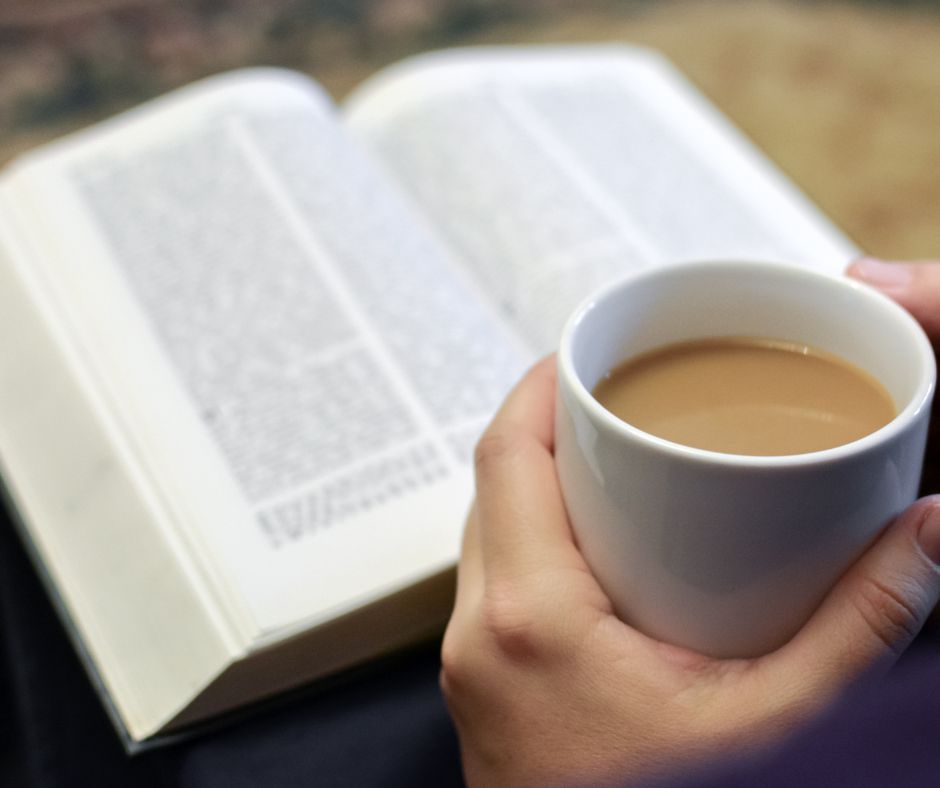 A hand holding a coffee mug at a faith based gathering for female entrepreneurs.