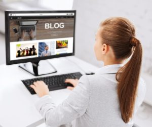 A woman sitting at her desk blogging!