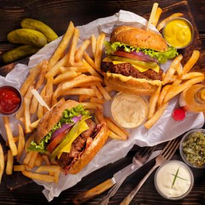A basket of burgers is featured with fries and sauces for the Best Burgers In Tampa 2024.