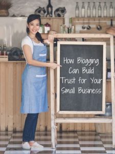 A couple of happy small business owners in front of a chalkboard sign for How Blogging Can Build Trust for Your Small Business.