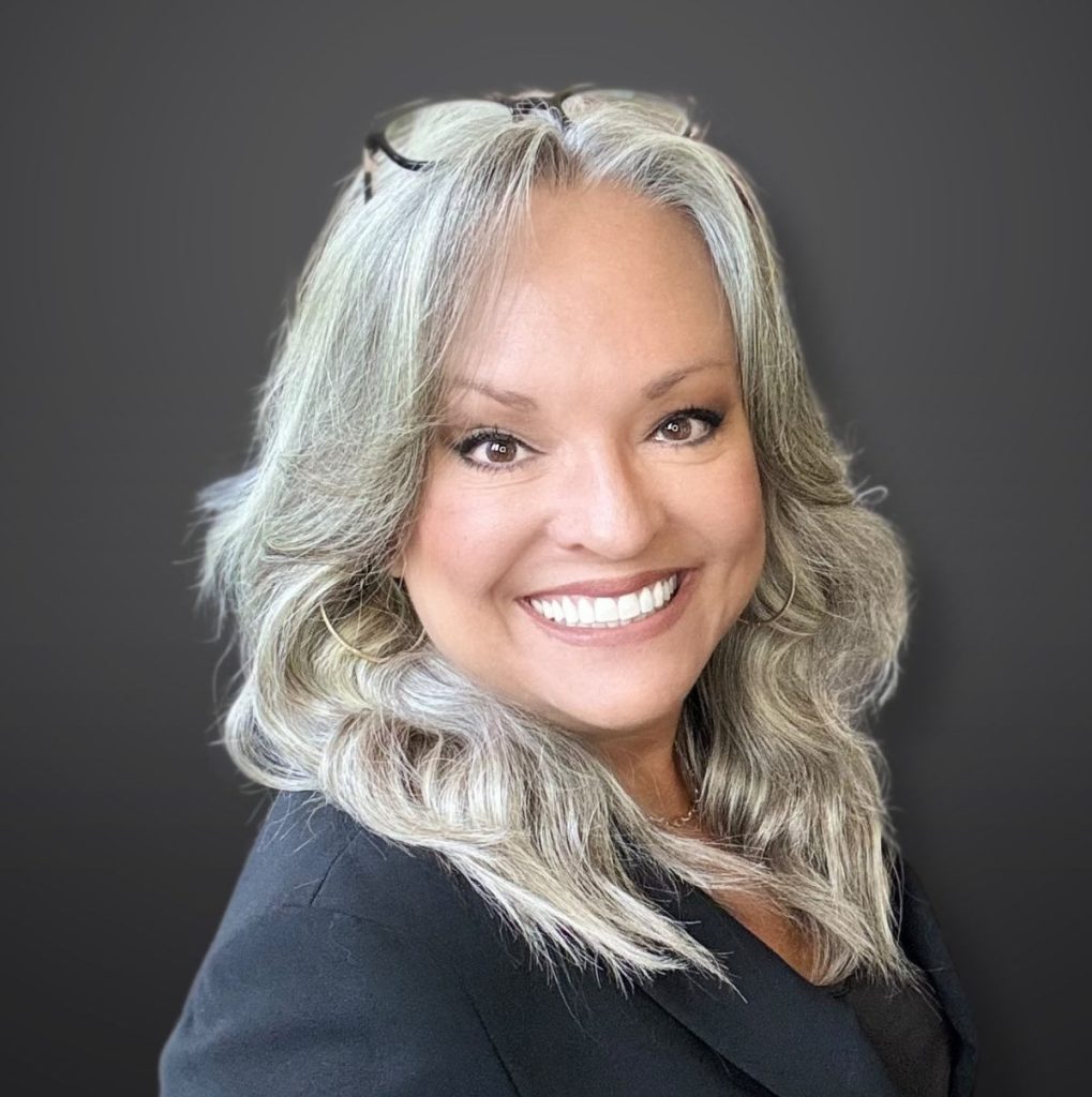 SImply Sunni professional headshot in black background.