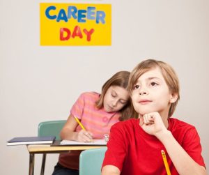 Career Day sign is on the wall and a boy is listening at his desk.