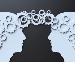 Communication is the best way to work as a team A graphic image of gears goind between two brains.