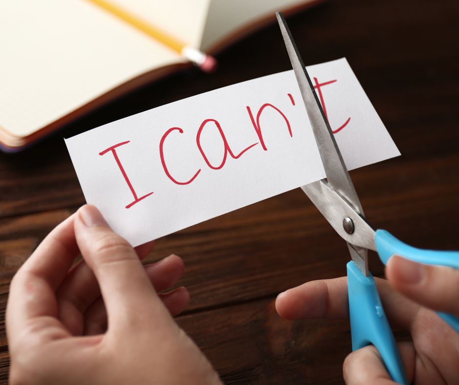 A picture of a girl cutting the word Can't