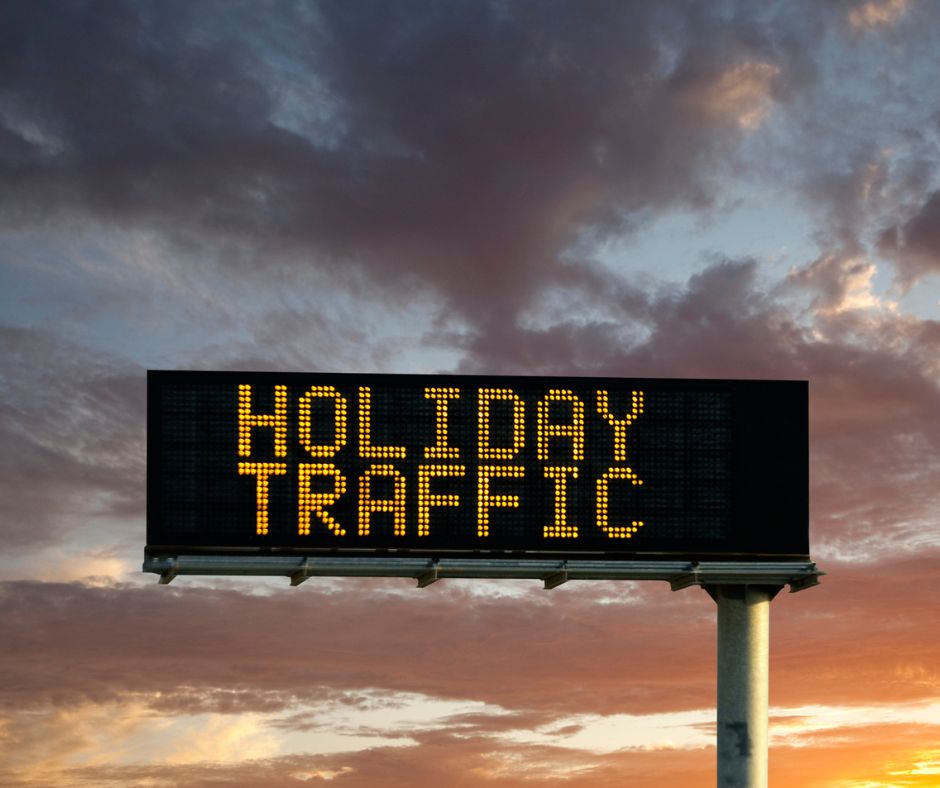 Drive Holiday Traffic image of a lit street sign that says Holiday Traffic.