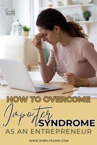 A woman sitting in front of a computer for the post for How to Overcome Imposter Syndrome as an entrepreneur.