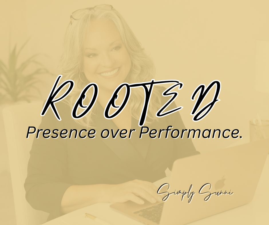 A photo of Sunni at her desk with the laptop with the overlay ROOTED: Presence over Performance.